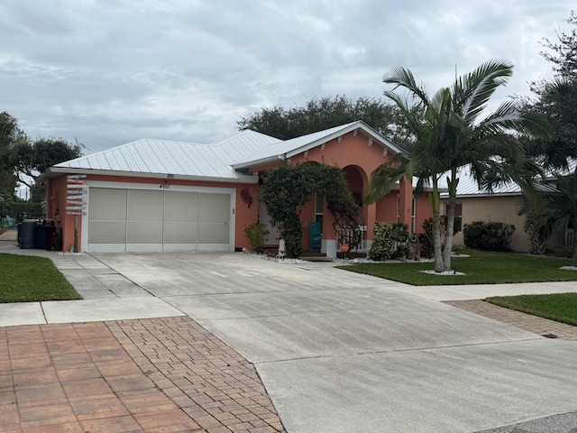 ranch-style home featuring a front yard and a garage