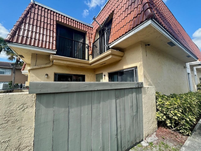 view of side of property with a balcony