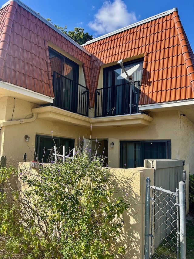 back of house with a balcony