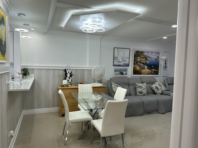 dining area with crown molding and a textured ceiling