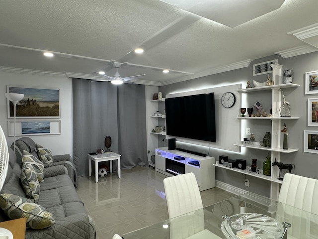 living room featuring crown molding, ceiling fan, and a textured ceiling