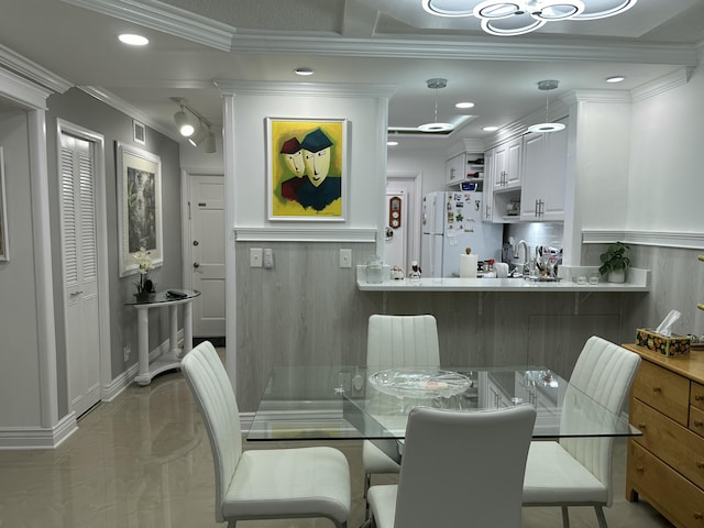 dining area featuring crown molding