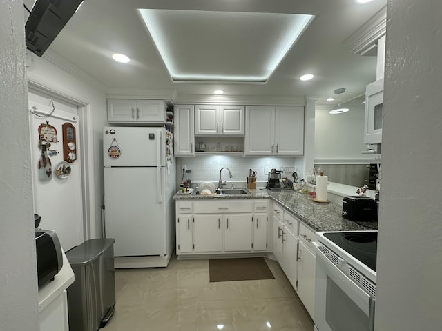 kitchen featuring sink, white appliances, stone counters, white cabinets, and decorative backsplash