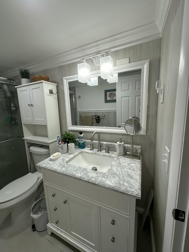 bathroom with vanity, crown molding, and toilet