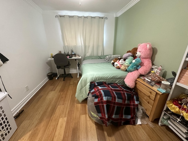 bedroom with crown molding and light hardwood / wood-style floors