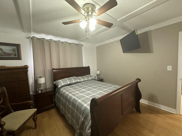 bedroom with coffered ceiling, crown molding, light hardwood / wood-style flooring, a textured ceiling, and ceiling fan