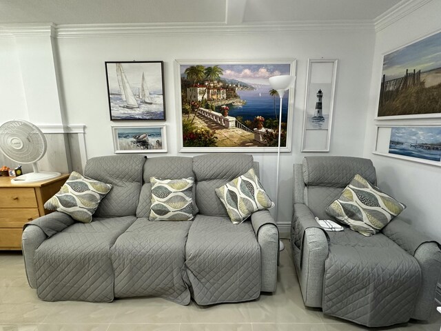 tiled living room with ornamental molding