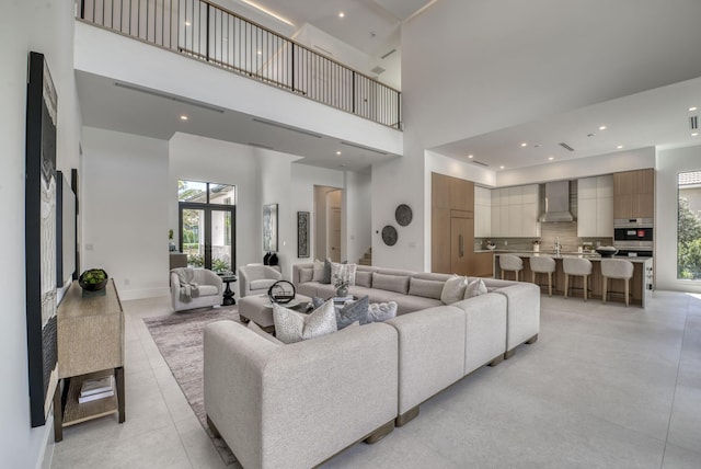 tiled living room featuring a high ceiling