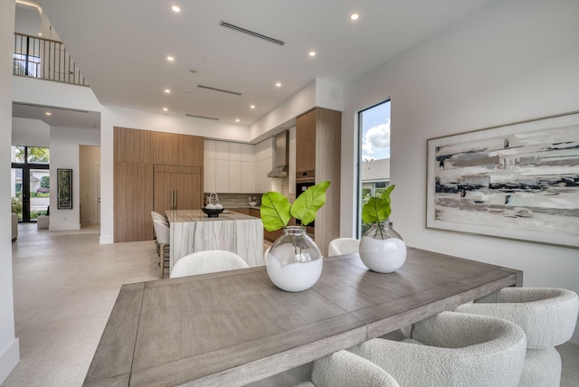 dining space featuring a high ceiling