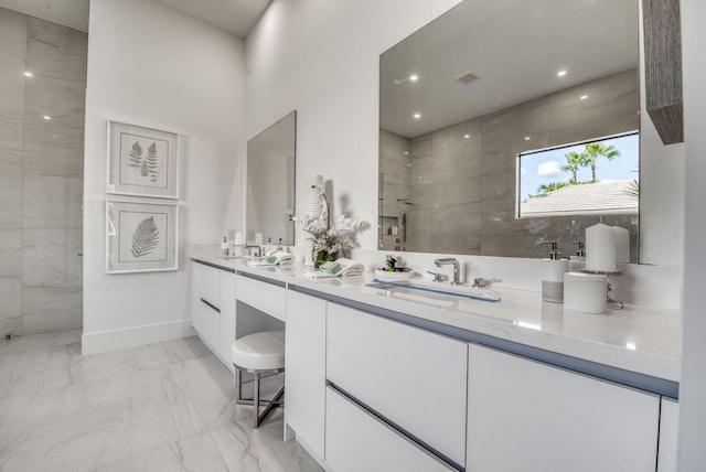 bathroom with vanity and a tile shower