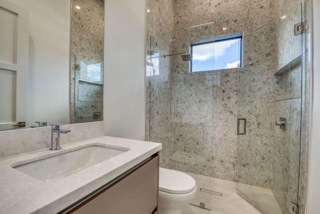 bathroom with vanity, an enclosed shower, and toilet