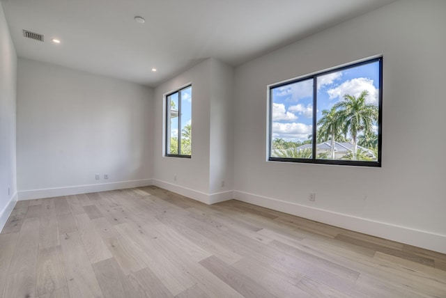 spare room with light hardwood / wood-style floors