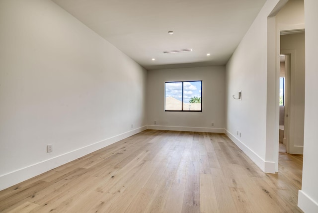 spare room with light hardwood / wood-style flooring