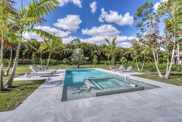 view of swimming pool with a yard, a patio, and an in ground hot tub