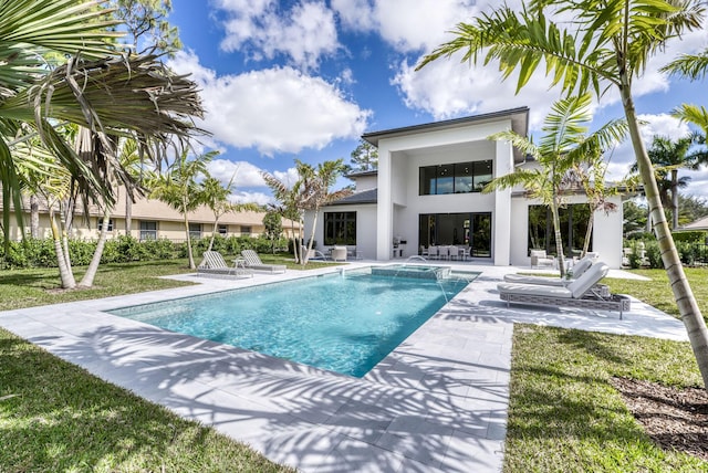 view of swimming pool featuring a patio and a yard