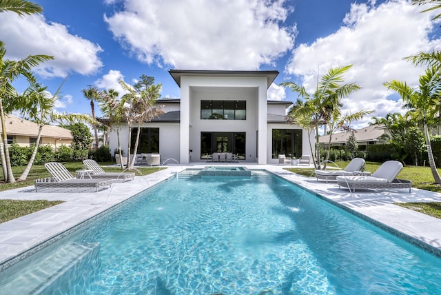 rear view of house with pool water feature and a patio area