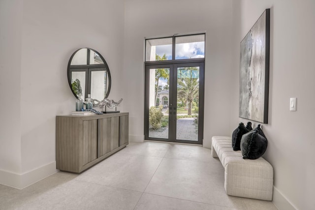 foyer entrance with french doors and a high ceiling