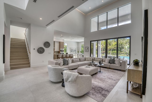 living room with a high ceiling and plenty of natural light