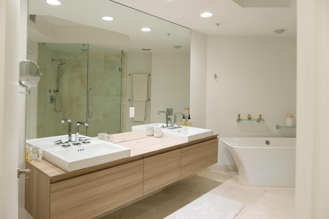 bathroom featuring tile patterned flooring, vanity, and separate shower and tub