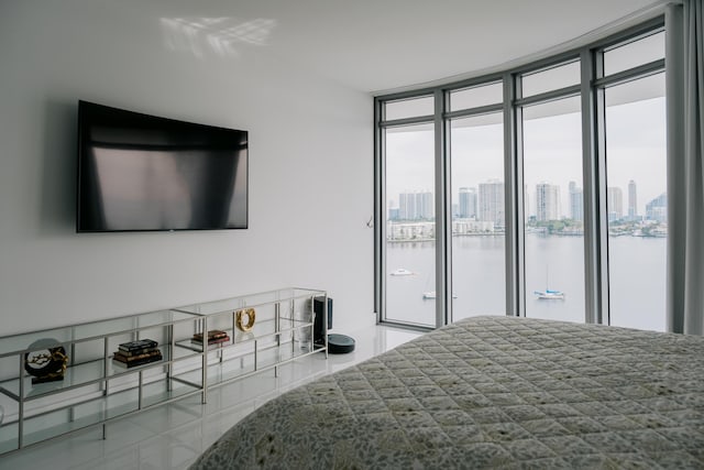 bedroom featuring a water view and access to outside