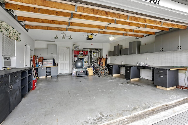 garage featuring a garage door opener and a workshop area