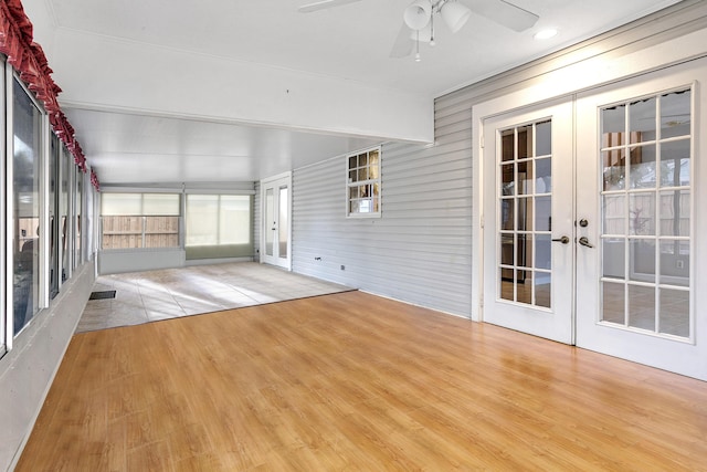 unfurnished sunroom with french doors and ceiling fan