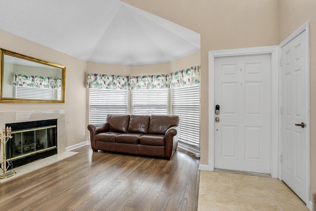 living room with a premium fireplace and light hardwood / wood-style floors