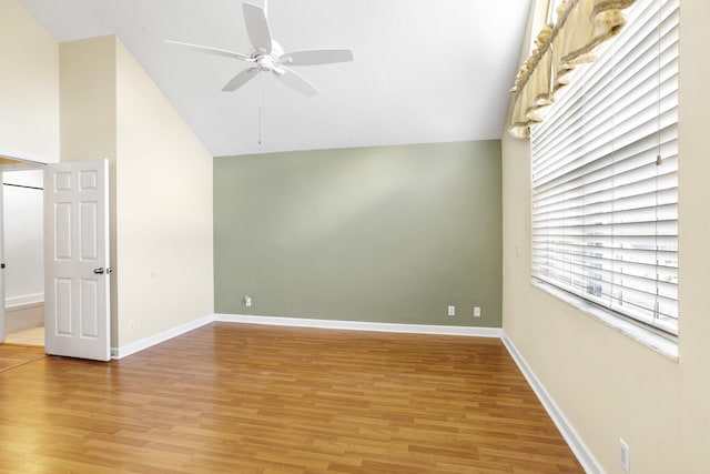 unfurnished room featuring wood-type flooring, high vaulted ceiling, and ceiling fan