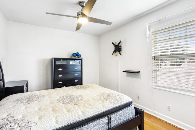 bedroom with wood-type flooring and ceiling fan