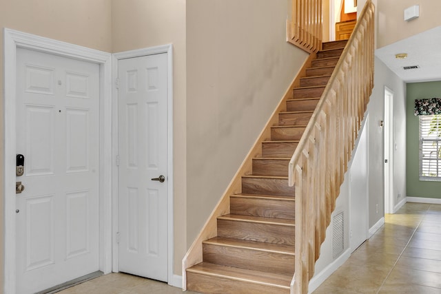 staircase with tile patterned floors