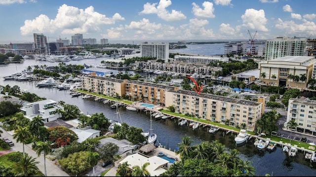 drone / aerial view featuring a city view and a water view