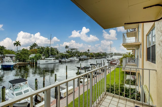 balcony with a water view and a boat dock