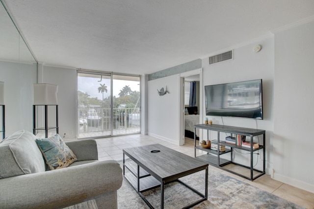 tiled living room featuring ornamental molding and floor to ceiling windows