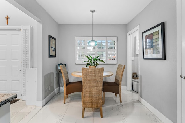 dining room featuring marble finish floor and baseboards