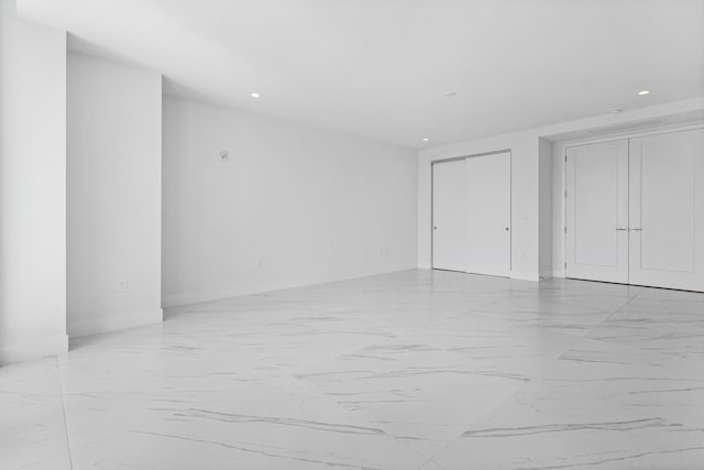 interior space with marble finish floor and recessed lighting