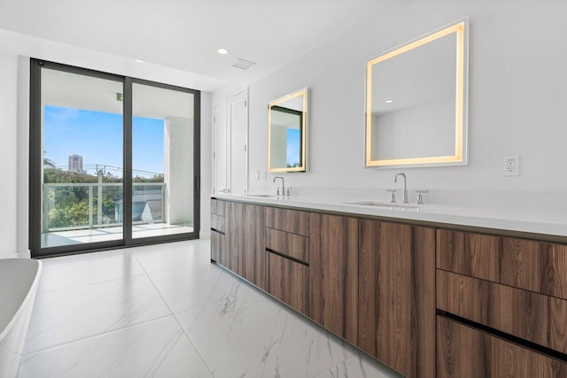 bathroom with marble finish floor, double vanity, a sink, and visible vents