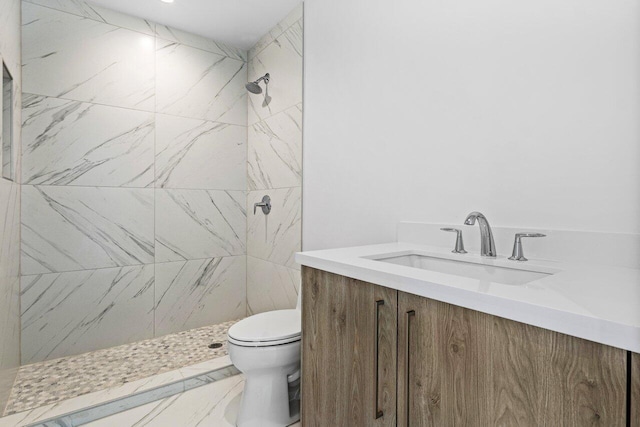 bathroom with toilet, a shower stall, and vanity