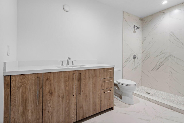 full bath with toilet, marble finish floor, a shower stall, and vanity