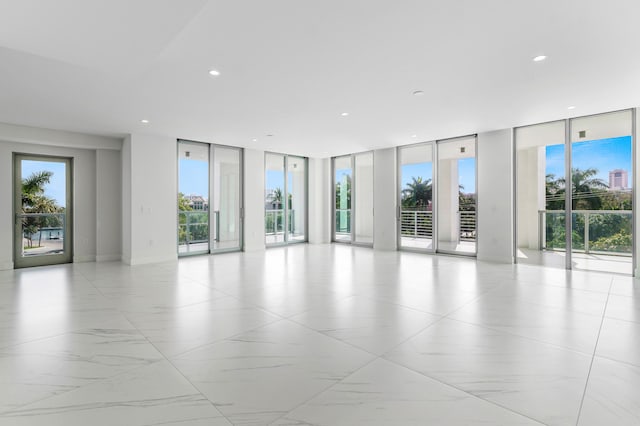 spare room featuring expansive windows, plenty of natural light, and recessed lighting