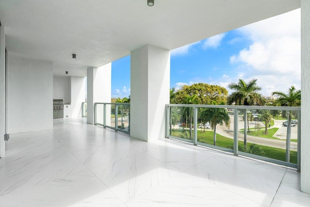 interior space featuring a healthy amount of sunlight and marble finish floor