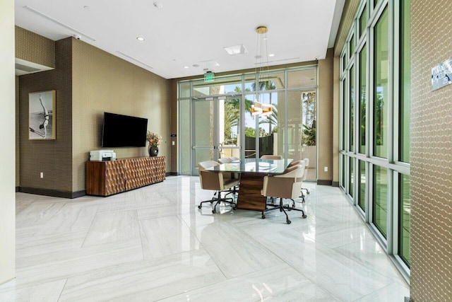 office area with wallpapered walls, baseboards, a wall of windows, and recessed lighting