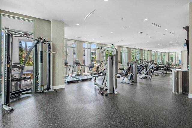 exercise room with a healthy amount of sunlight, visible vents, and recessed lighting