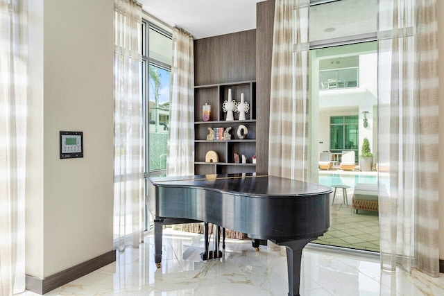 interior space featuring marble finish floor and baseboards