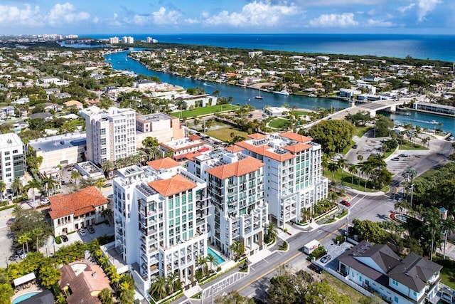 birds eye view of property featuring a water view and a city view