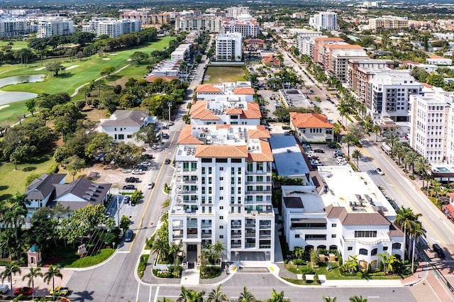 drone / aerial view featuring view of golf course and a city view