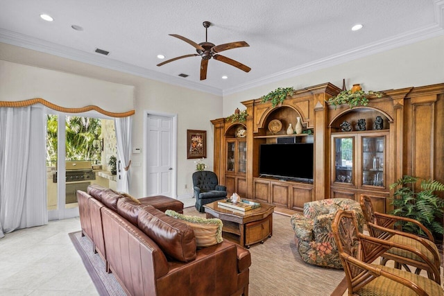 living room with ceiling fan, ornamental molding, a textured ceiling, and light tile patterned floors