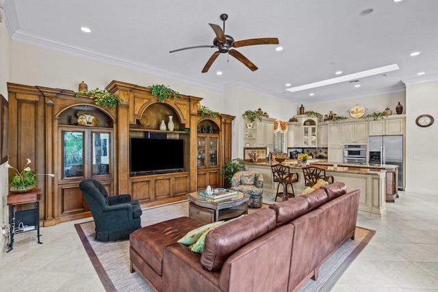 tiled living room with ceiling fan and ornamental molding