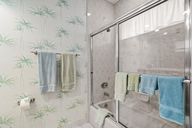 bathroom featuring combined bath / shower with glass door