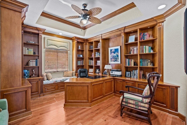 office area featuring a textured ceiling, ornamental molding, a tray ceiling, ceiling fan, and light hardwood / wood-style floors