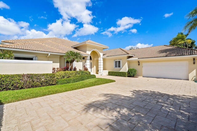 mediterranean / spanish-style house with a garage